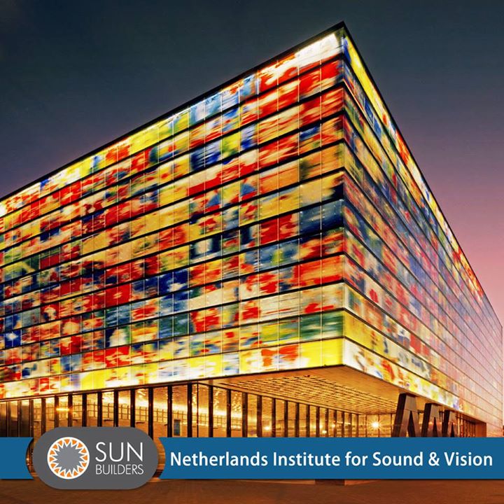 The Netherlands Institute for Sound and Vision is one of the largest audiovisual archives in Europe. Designed by architects Willem-Jan Neutelings and Michiel Riedijk, the striking cubic form of the building is clad externally on all faces with coloured glass panels resembling a huge, shimmering screen mesmerizing its visitors. #Landmark #Architecture